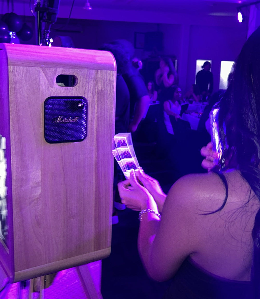 Person holding a smartphone with a purple filter in front of a Marshall amplifier.